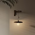 Wall Sconce with Wooden Arm Metal Shade and Warm Bulb on Beige Wall with Leaves