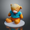 Yellow Stuffed Bear Wearing Blue Shirt With Footprints On Paws Sitting On White Base