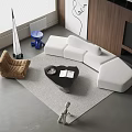 Modern White L Shaped Sofa With Black Coffee Table And Accent Chair On Rug