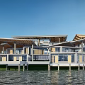 Modern Waterfront Guesthouse Buildings With Wooden Decks Overlooking Water And Green Lawn