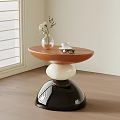Modern Side Table with Brown Top White Black Base Vase Coffee Cup and Glasses