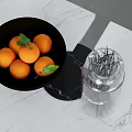 Fresh Oranges in Black Bowl With Green Leaves and Glass Bottle on White Marble