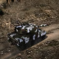 Military Tank In Outdoor Grassland And Forest Area