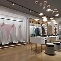 Elegant Shopping Mall Bridal Boutique Store With Hanging Wedding Dresses And Mirrored Counter Stools