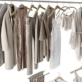 Stylish Clothes With Dresses Tops Coats Bags Hats And Suitcases In Neutral Tones On Hangers
