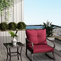Red Comfortable Lounge Chair On Balcony With Side Table Green Plants Ocean View And Cityscape