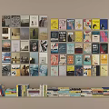 Colorful Books And Magazines Display Various Covers Stacked On Home Library Wall