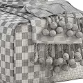 Stylish Yellow and Green Ottoman with Gray Pom Pom Blanket and Brown Strap Detail