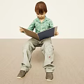 Man Sitting On The Floor Reading A Book Wearing Green Shirt And Gray Pants