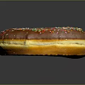 Delicious Chocolate Frosted Donut Topped With Colorful Sprinkles On Black Background