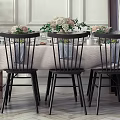 Elegant Dining Table Set With Black Chairs Tablecloth And Flower Centerpieces