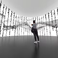 Museum Exhibition Featuring Flowing Art Installation With Hanging Black Characters And White Gray Background