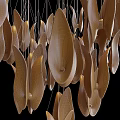 Modern Leaf Shaped Gold And White Chandelier With Illuminated Design Against Black Background