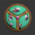 Decorative Circular Artifact With Brown Outer Frame Green Base Pink Floral Patterns And Central Pink Gemstone