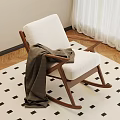 Wooden Rocking Chair With White Cushion And Brown Blanket On Checkered Rug
