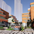 Modern Orange Office Building With Glass Elements And Landscaped Plaza Entrance Area