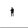 Man in dark coat gray pants brown shoes pointing to side with light brown background