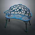 Blue Metal Garden Bench With Ornate Floral Cutout Patterns And Curved Frame