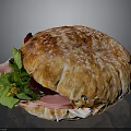 Tasty Ham Sandwich With Fresh Greens Creamy Sauce on Flour Dusted Crusty Bread