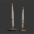 Lit White Candles On Decorative Metal Candle Holders With Intricate Patterns