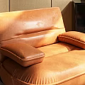 Light Beige Single Seater Sofa With Green Throw Blanket Golden Floor Lamp And Light Rug