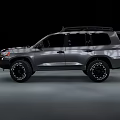 Dark Colored SUV With Off Road Tires Roof Rack And Rugged Exterior Design
