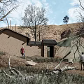 Two People Walking Near Dilapidated Houses With Leafless Trees Barren Grassland Hills And Sky