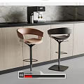Modern Kitchen Interior With Stylish Brown And Black Bar Stools By Counter Area