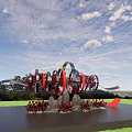 Floral Art Installation With Red Black Sculptural Floral Design Dynamic Ribbon On Green Lawn