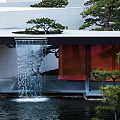 Serene Garden Landscape With Green Lawn Pine Trees White Buildings And Open Sky