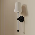 Modern Wall Sconce With White Fabric Shade And Black Metal Frame On Beige Wall