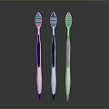 Three Different Colored Toothbrushes With White Brush Heads And Colored Bristles For Daily Use