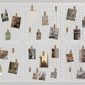 Photo Wall with White Perforated Board and Wooden Clips Holding Various Photos and Cards