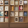 Wooden Bookshelf Filled With Various Colorful Book Spines And Art Prints