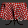 Round Dining Table With Red And White Checkered Tablecloth And Wooden Legs