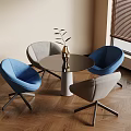 Modern Interior With Round Table Blue And Gray Chairs Vase Plants And Wooden Floor