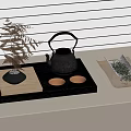 Traditional Tea Set Arrangement With Black Teapot Teacups Green Plant And Tea Leaves