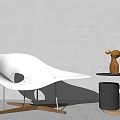 White Modern Lounge Chair With Curved Design And Hollow Cutout By Side Table