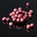 Juicy Red Plums in Transparent Bowl and Scattered on Black Surface