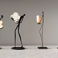 Modern Human Shaped Floor Lamps Featuring White Spheres And Candle Holders