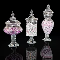 Colorful Candies in Transparent Glass Jars With Decorative Lids and Reflective Bases