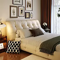 Beige Upholstered Double Sofa in Bedroom with Framed Pictures Table Lamp and Green Throw