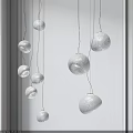 Multiple Modern Textured Paper Round Pendant Lights Hanging In Minimalist Interior Space