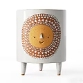 White Vase With Sun Face Design Featuring Yellow Flowers And Green Leaves