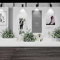 Elegant Wedding Stage Decor With Floral Arrangements And Photo Posters