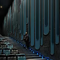 Cinema Interior With Dark Walls Blue Vertical Stripes Staircase Seats Blue Lighting And Standing Person