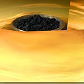 Golden Decorative Bowl With Intricate Base Holding Black Granules And Small Gear