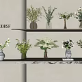 Stylish Flower Vases With Mixed Blooms On Layered Shelves Against Light Wall