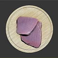 Fresh Tuna Meat Pieces Displayed On Round Wooden Cutting Board