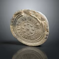 Ancient Stone Circular Relief Carving With Intricate Floral Patterns And Textured Surface